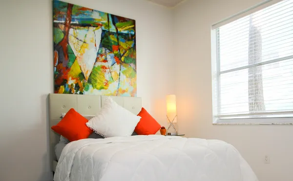 a bedroom with a bed and a window