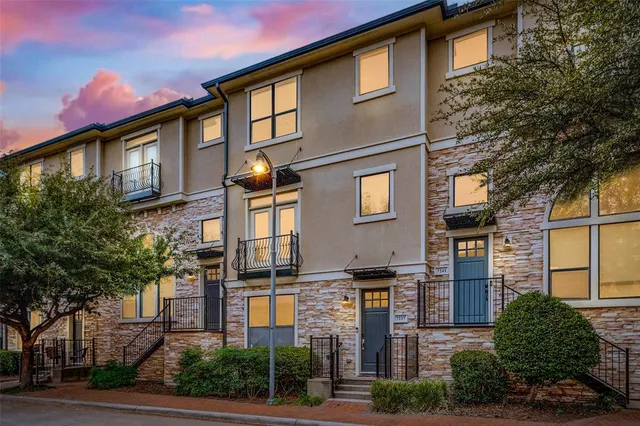 a front view of a residential apartment building with a yard