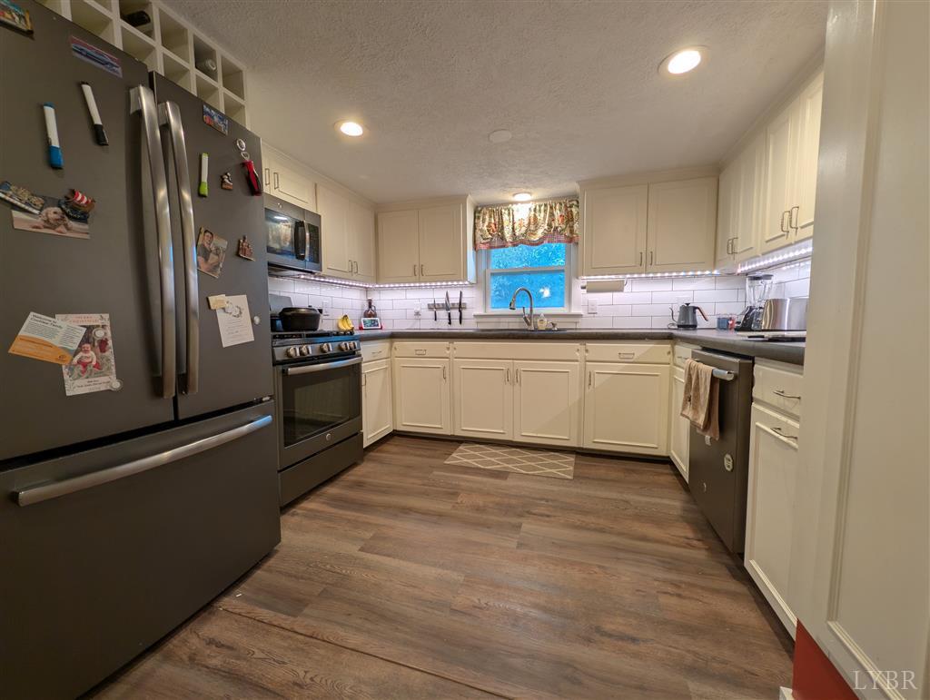 4470 Red Oak School Road Concord, VA 24538 - Photo 11 of 30 a kitchen with stainless steel appliances granite countertop a sink and a stove