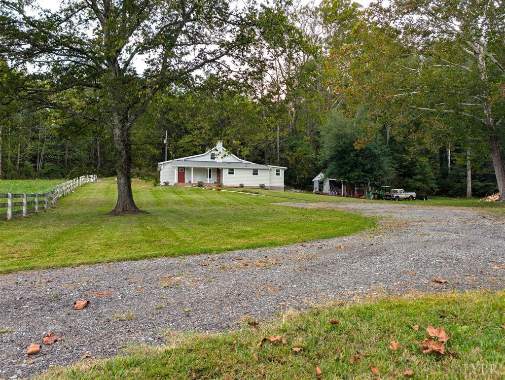 4470 Red Oak School Road Concord, VA 24538 - Photo 2 of 30 a view of a house with a big yard and large trees