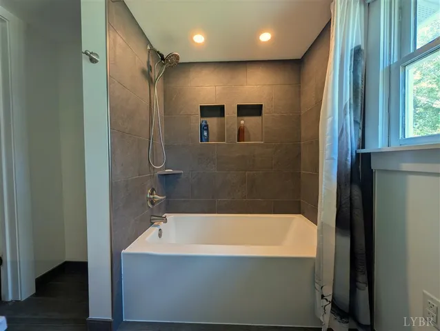 a bathroom with a bathtub and a shower