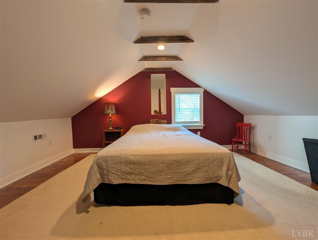 4470 Red Oak School Road Concord, VA 24538 - Photo 28 of 30 a bedroom with a large bed and a chandelier