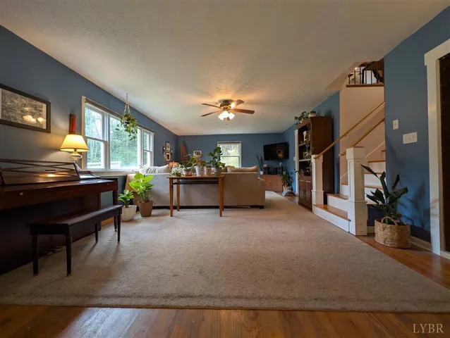 a living room with furniture and a piano