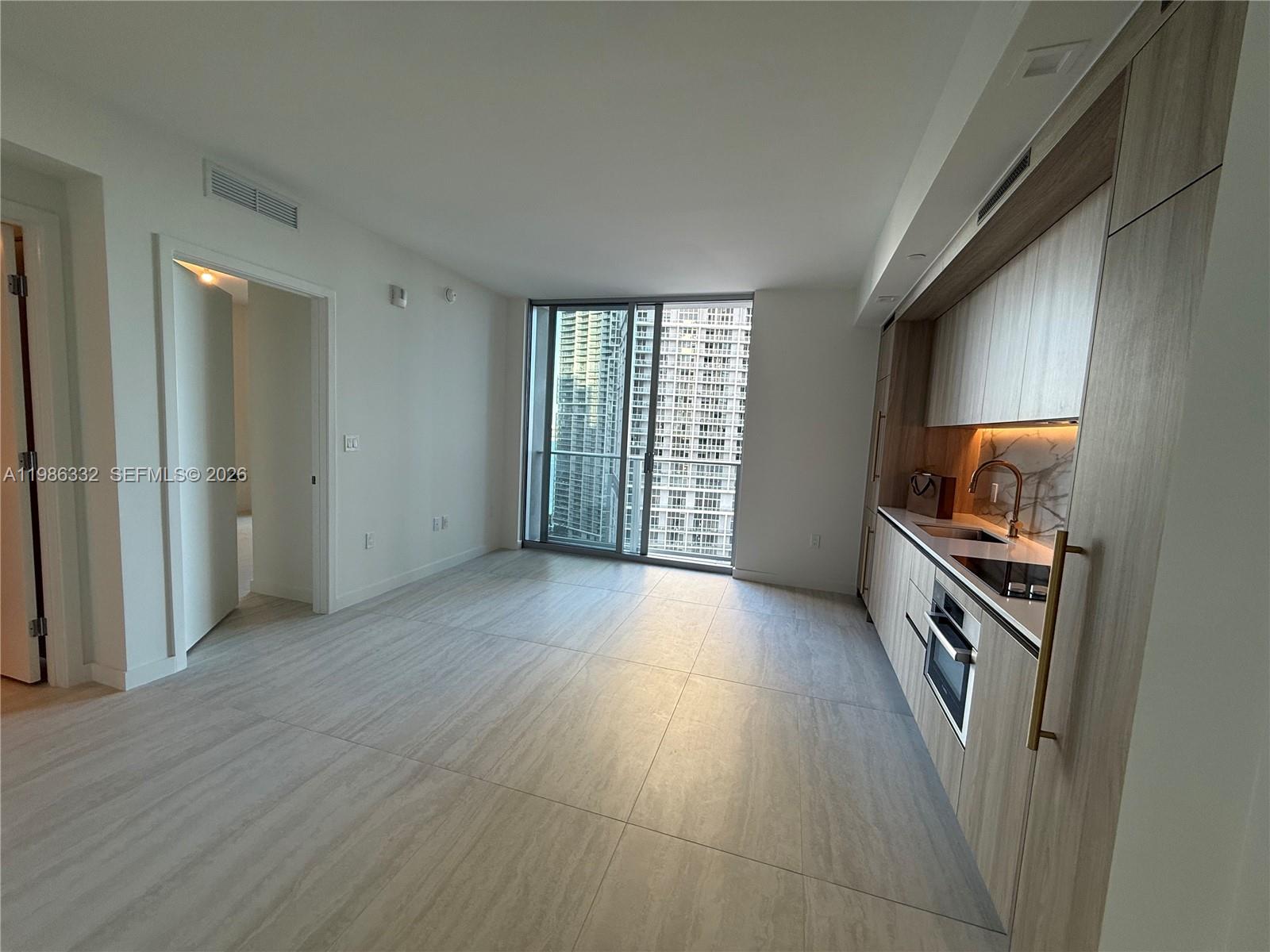 77 Southeast 5th Street, Unit 2015 Miami, FL 33131 - Photo 11 of 70 a view of a kitchen with a sink and a stove
