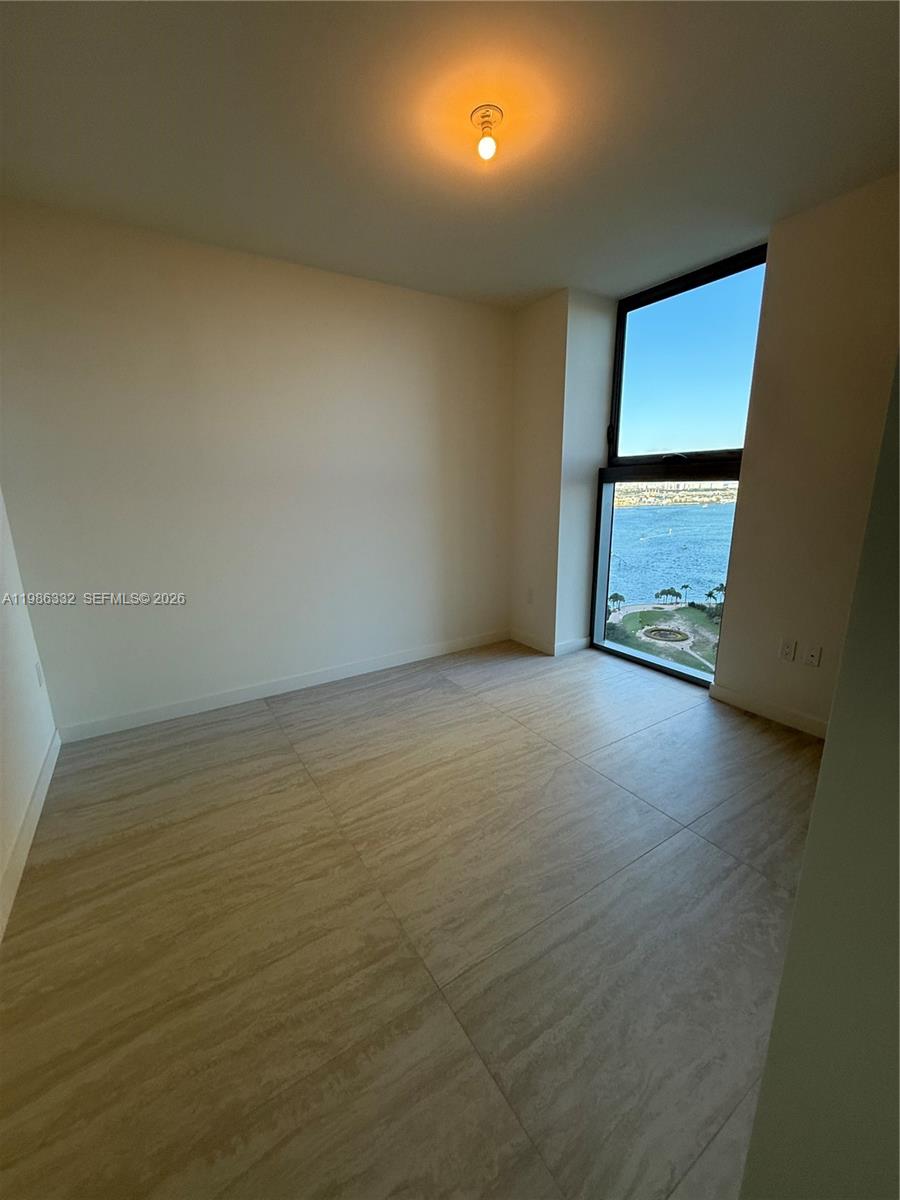 77 Southeast 5th Street, Unit 2015 Miami, FL 33131 - Photo 17 of 70 wooden floor in an empty room with a window