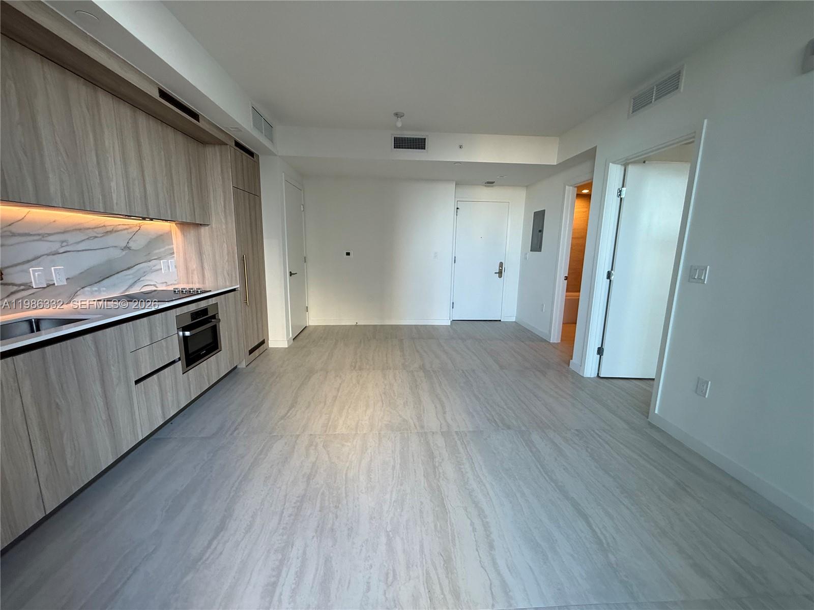 77 Southeast 5th Street, Unit 2015 Miami, FL 33131 - Photo 18 of 70 a view of an empty room with wooden floor