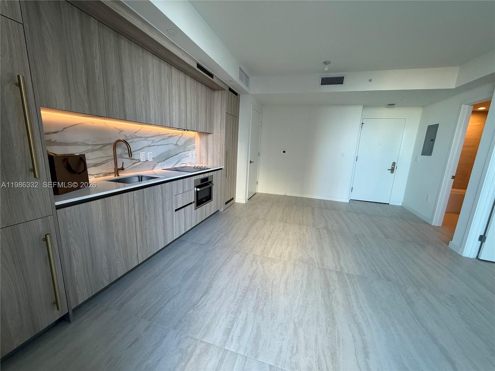 77 Southeast 5th Street, Unit 2015 Miami, FL 33131 - Photo 21 of 70 wooden floor in an empty room with a window