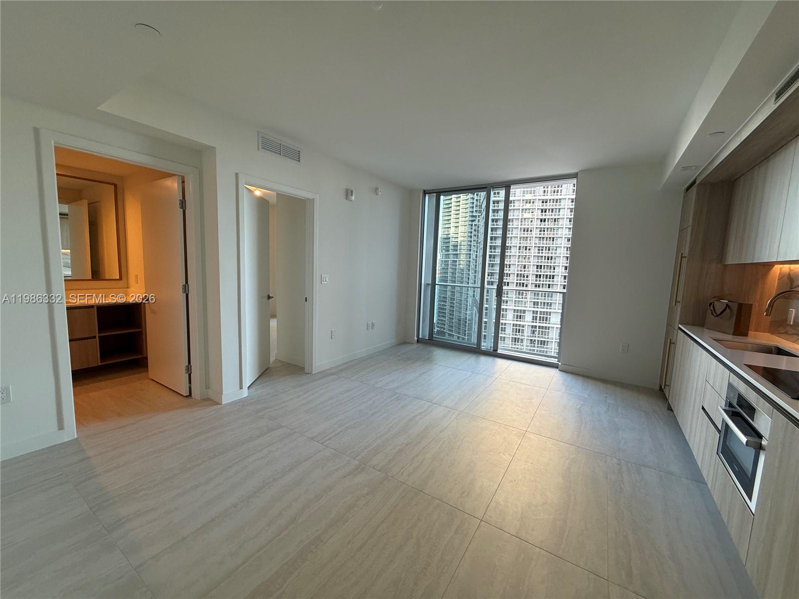 77 Southeast 5th Street, Unit 2015 Miami, FL 33131 - Photo 24 of 70 an empty room with windows and cabinet