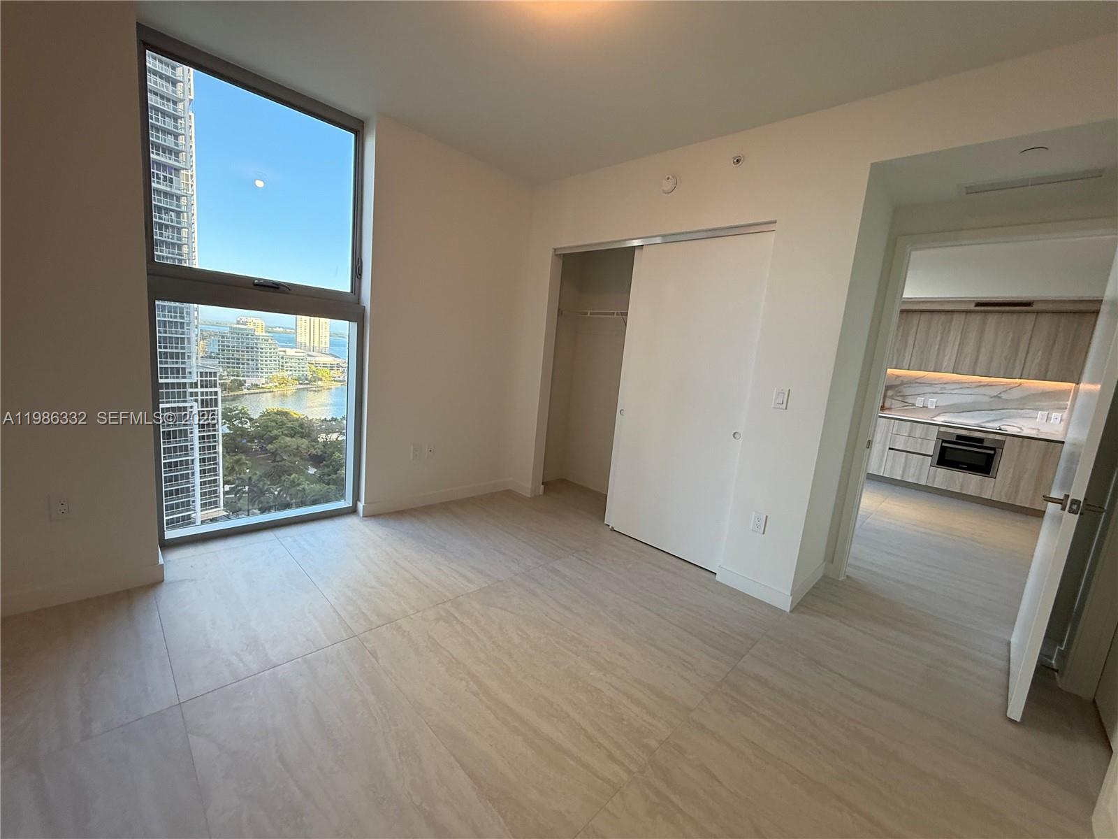 77 Southeast 5th Street, Unit 2015 Miami, FL 33131 - Photo 26 of 70 an empty room with wooden floor and windows