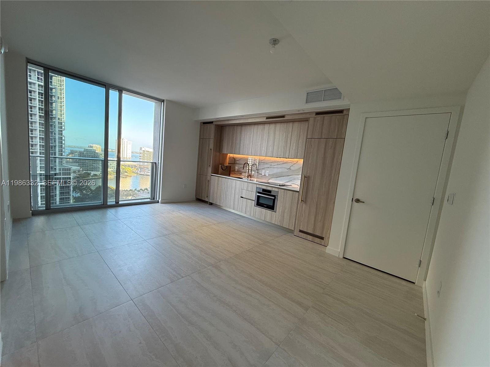 77 Southeast 5th Street, Unit 2015 Miami, FL 33131 - Photo 29 of 70 wooden floor in an empty room with a window