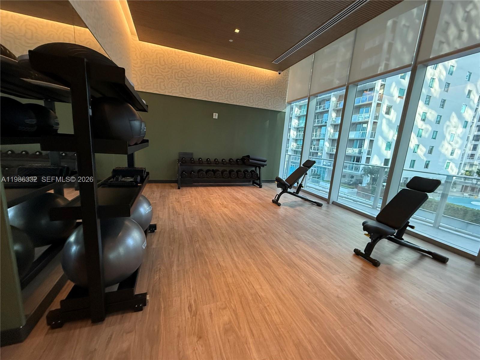 77 Southeast 5th Street, Unit 2015 Miami, FL 33131 - Photo 31 of 70 a living room with furniture and a wooden floor