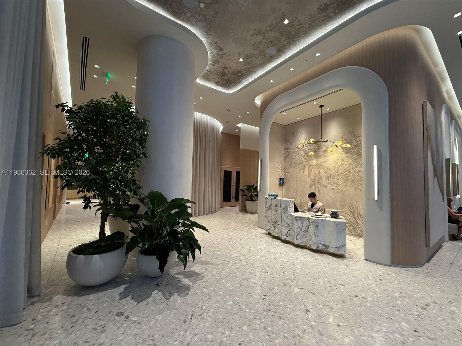 77 Southeast 5th Street, Unit 2015 Miami, FL 33131 - Photo 39 of 70 a lobby with furniture and a potted plant