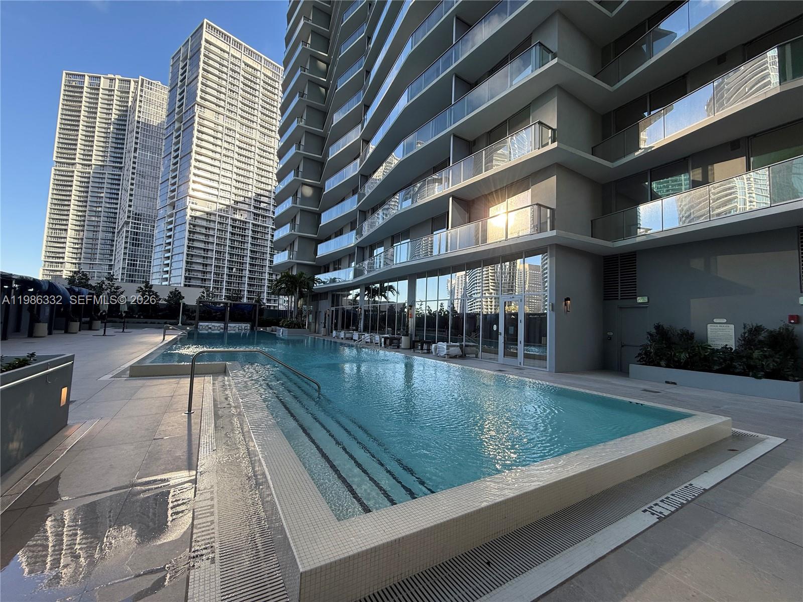 77 Southeast 5th Street, Unit 2015 Miami, FL 33131 - Photo 42 of 70 a view of swimming pool with outdoor seating
