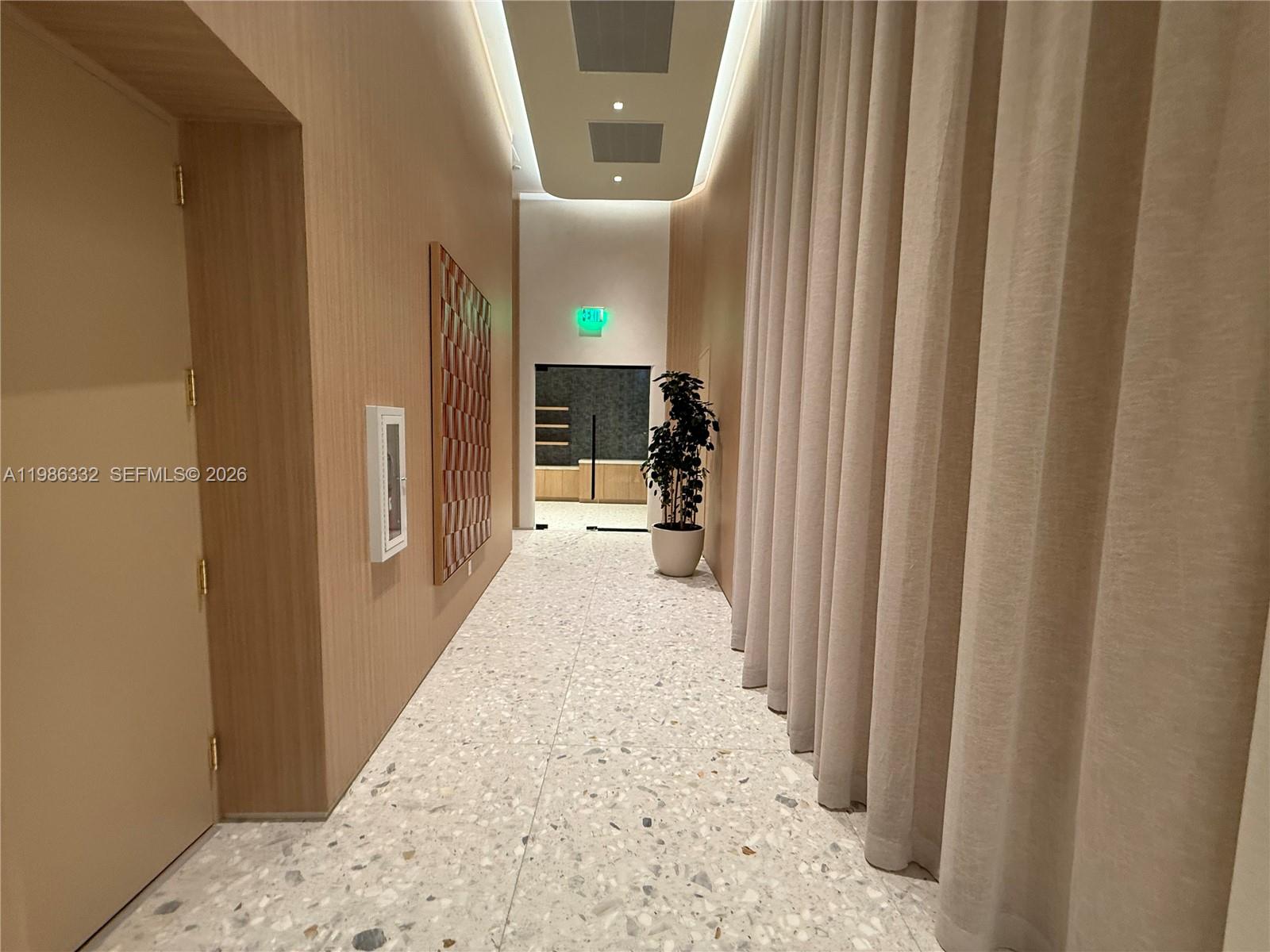 77 Southeast 5th Street, Unit 2015 Miami, FL 33131 - Photo 44 of 70 a view of a hallway with wooden floor and staircase