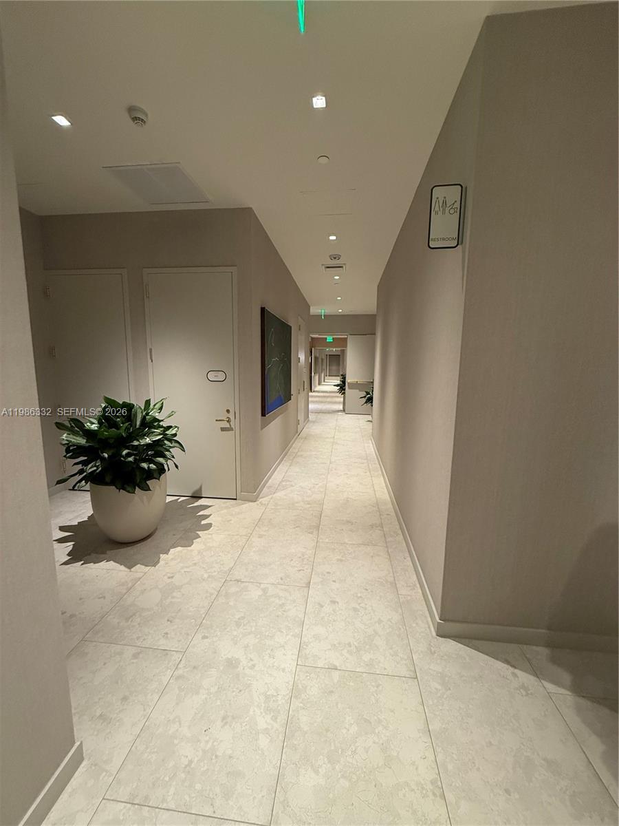 77 Southeast 5th Street, Unit 2015 Miami, FL 33131 - Photo 46 of 70 a view of a hallway and a livingroom with a potted plant