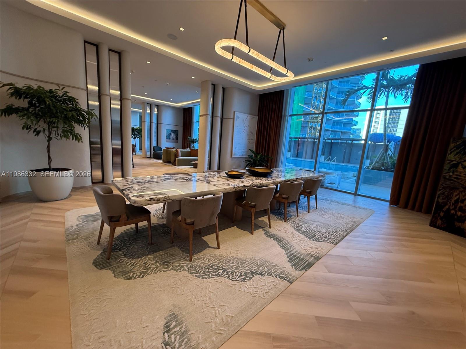 77 Southeast 5th Street, Unit 2015 Miami, FL 33131 - Photo 57 of 70 a view of a dining room with furniture window and wooden floor