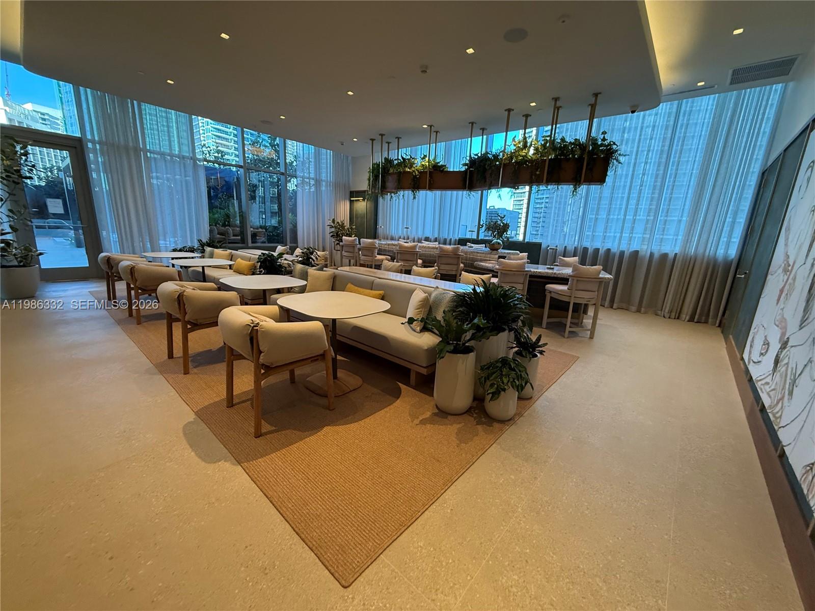 77 Southeast 5th Street, Unit 2015 Miami, FL 33131 - Photo 61 of 70 a living room with lots of furniture and a large window