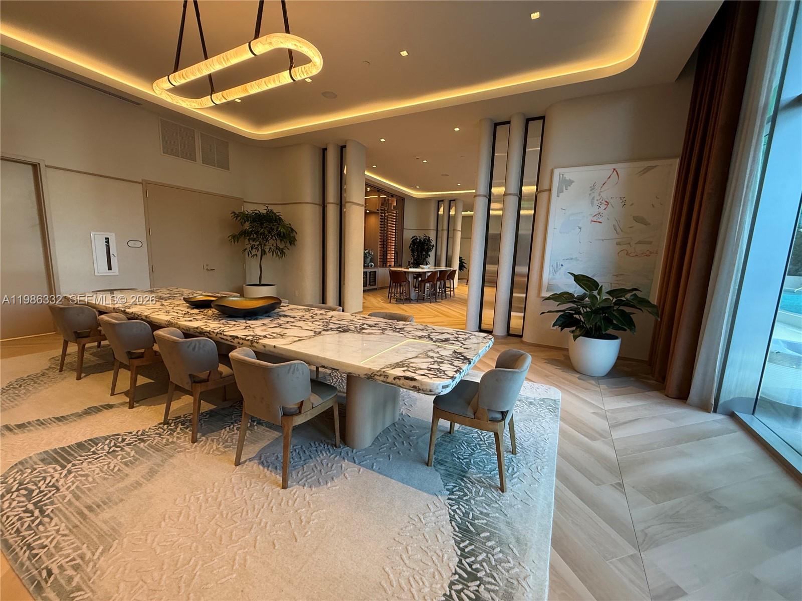 77 Southeast 5th Street, Unit 2015 Miami, FL 33131 - Photo 68 of 70 a outdoor dining space with furniture and a potted plant