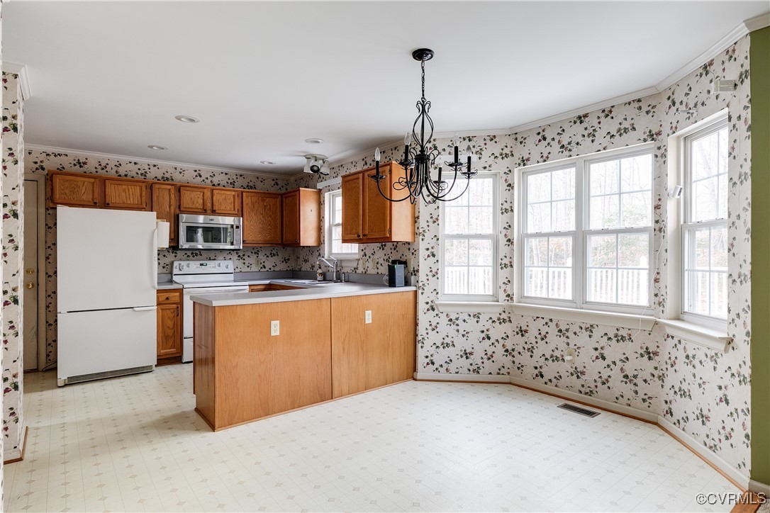 4588 Broad St Road Gum Spring, VA 23065 - Photo 17 of 50 a kitchen with stainless steel appliances granite countertop a stove a sink dishwasher a refrigerator and white cabinets with wooden floor