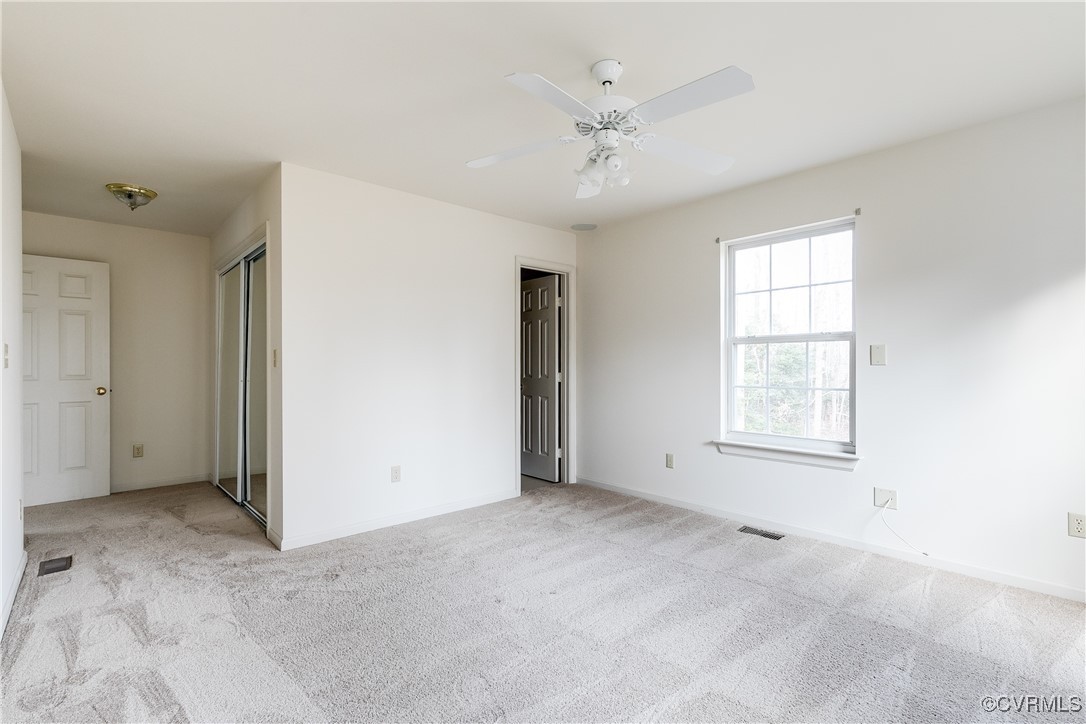 4588 Broad St Road Gum Spring, VA 23065 - Photo 26 of 50 an empty room with chandelier fan and windows