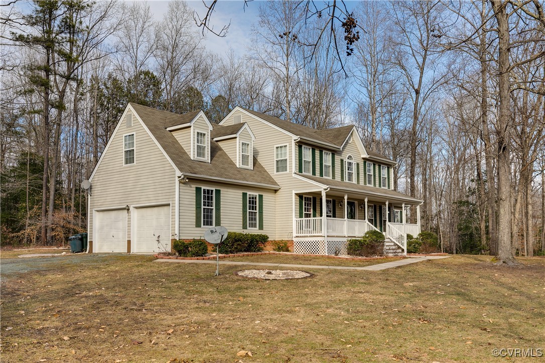 4588 Broad St Road Gum Spring, VA 23065 - Photo 3 of 50 a front view of a house with a yard and large trees