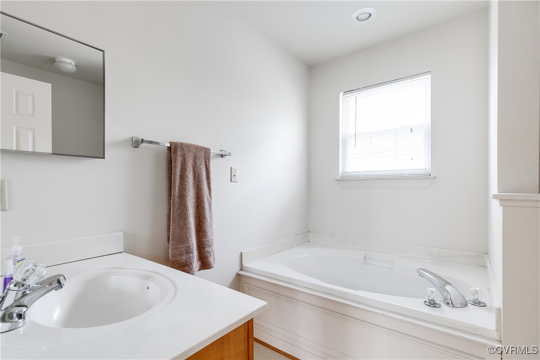 4588 Broad St Road Gum Spring, VA 23065 - Photo 47 of 50 a bathroom with a tub sink and a window
