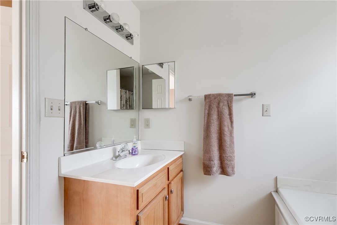 4588 Broad St Road Gum Spring, VA 23065 - Photo 49 of 50 a bathroom with a sink vanity and a mirror