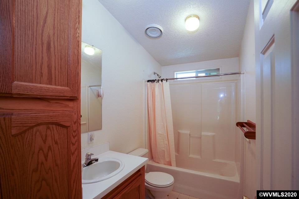 17265 Butler Hill Road Dallas, OR 97338 - Photo 32 of 38 a bathroom with a sink a toilet and shower