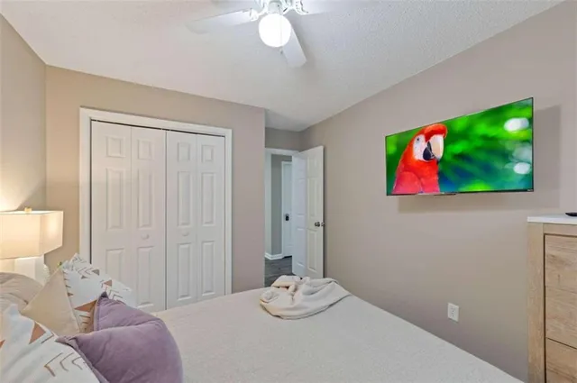 a bedroom with a bed and a painting on the wall