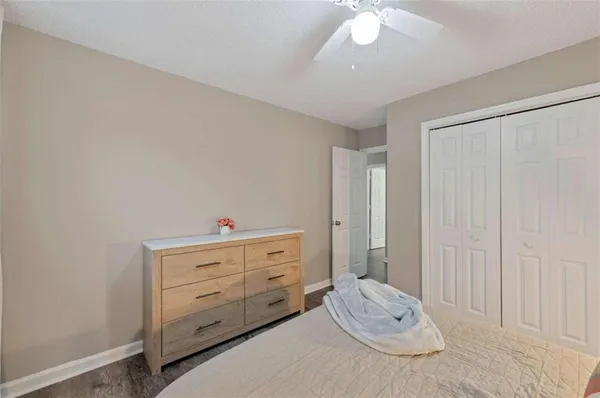 a room with a baby crib and dresser