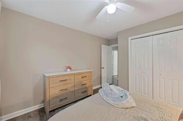 a room with a baby crib and dresser