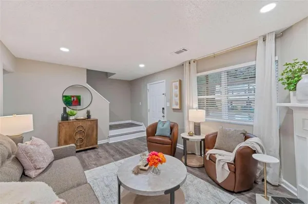 a living room with furniture and a lamp