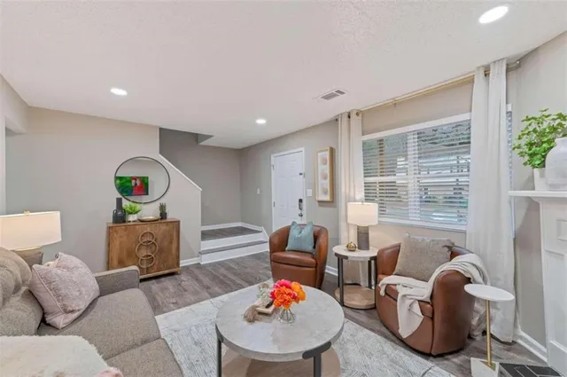 a living room with furniture and a lamp