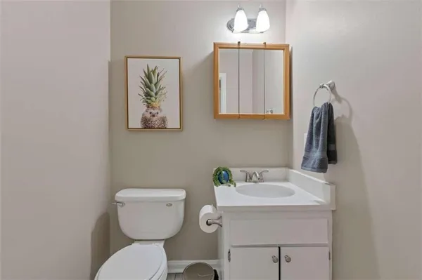 a bathroom with a toilet a sink and mirror