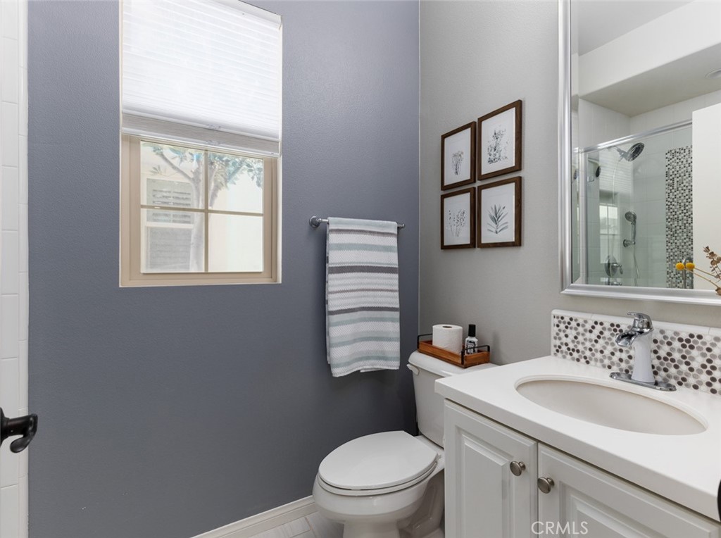 193 Barnes Road Tustin, CA 92782 - Photo 16 of 45 a bathroom with a sink a toilet and a window