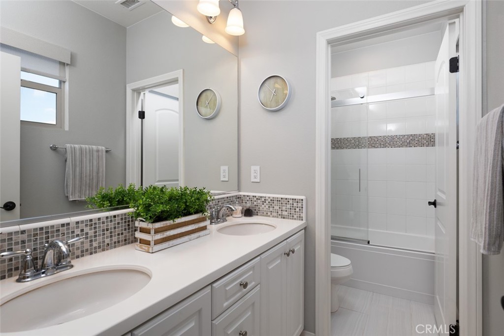 193 Barnes Road Tustin, CA 92782 - Photo 20 of 45 a bathroom with a granite countertop sink mirror and a shower