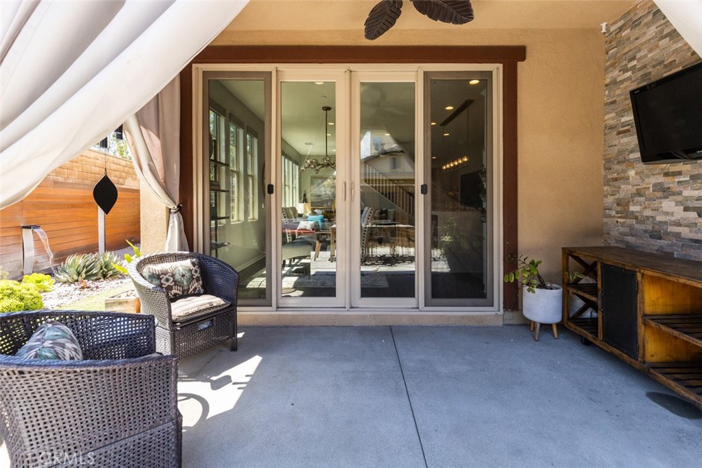 193 Barnes Road Tustin, CA 92782 - Photo 25 of 45 a living room with furniture a flat screen tv and a fireplace