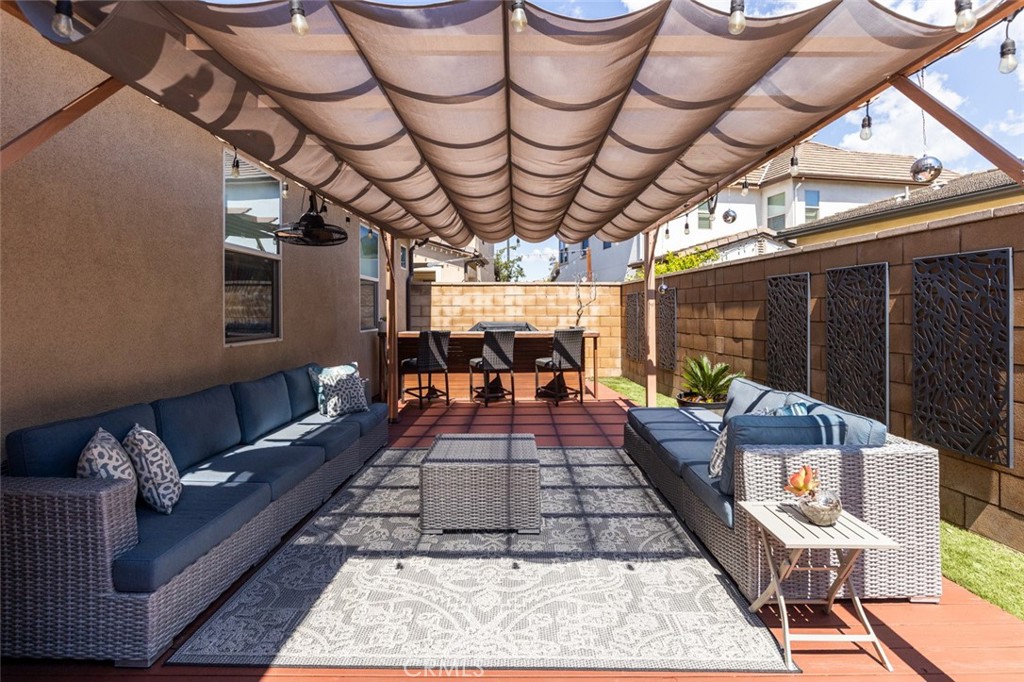 193 Barnes Road Tustin, CA 92782 - Photo 26 of 45 a outdoor space with lots of white furniture and a rug
