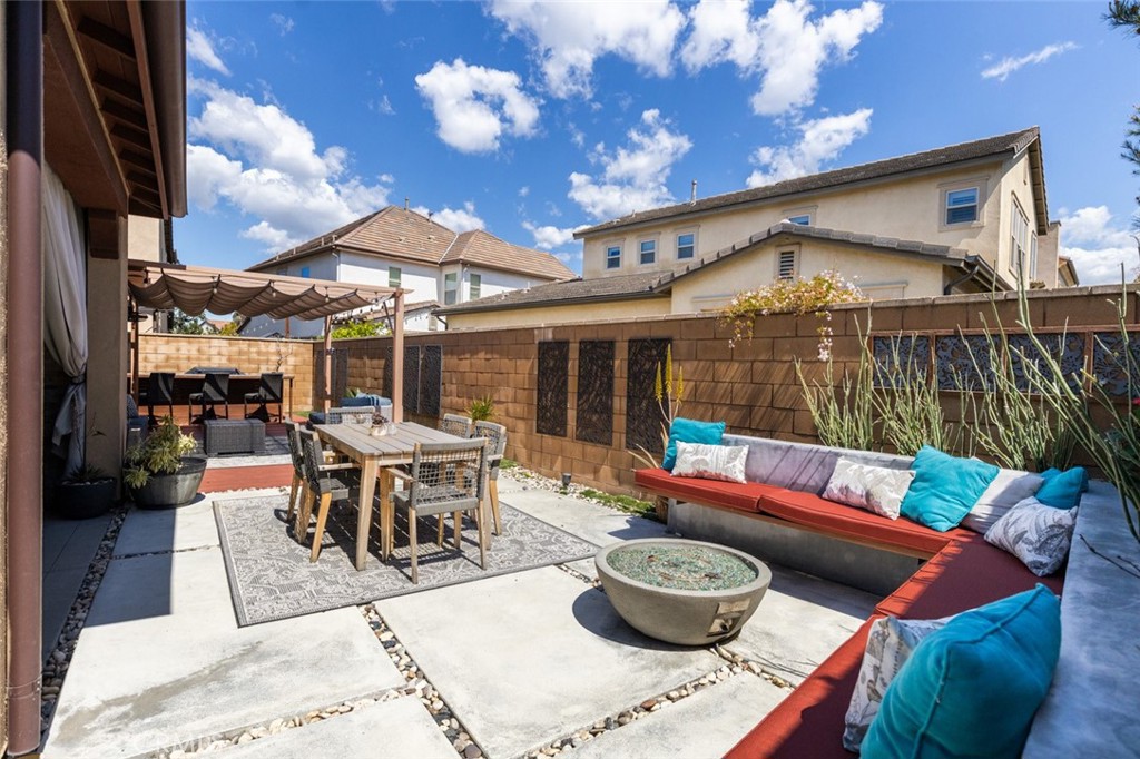 193 Barnes Road Tustin, CA 92782 - Photo 33 of 45 a view of a patio with a dining table and chairs with wooden floor