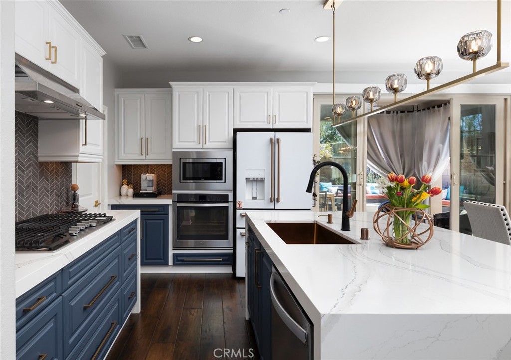 193 Barnes Road Tustin, CA 92782 - Photo 5 of 45 a kitchen that has a sink cabinets and stainless steel appliances