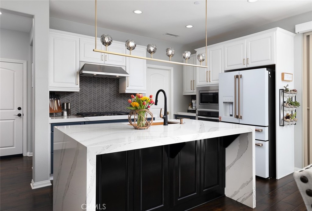 193 Barnes Road Tustin, CA 92782 - Photo 6 of 45 a kitchen with stainless steel appliances a sink stove refrigerator and cabinets