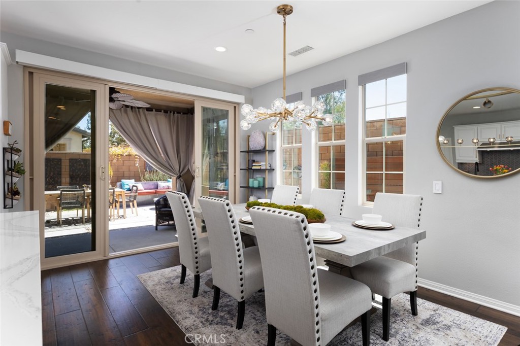 193 Barnes Road Tustin, CA 92782 - Photo 8 of 45 a dining room with furniture a chandelier and wooden floor