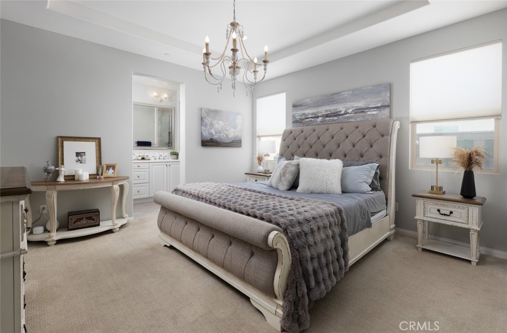 193 Barnes Road Tustin, CA 92782 - Photo 9 of 45 a spacious bedroom with a bed and a chandelier