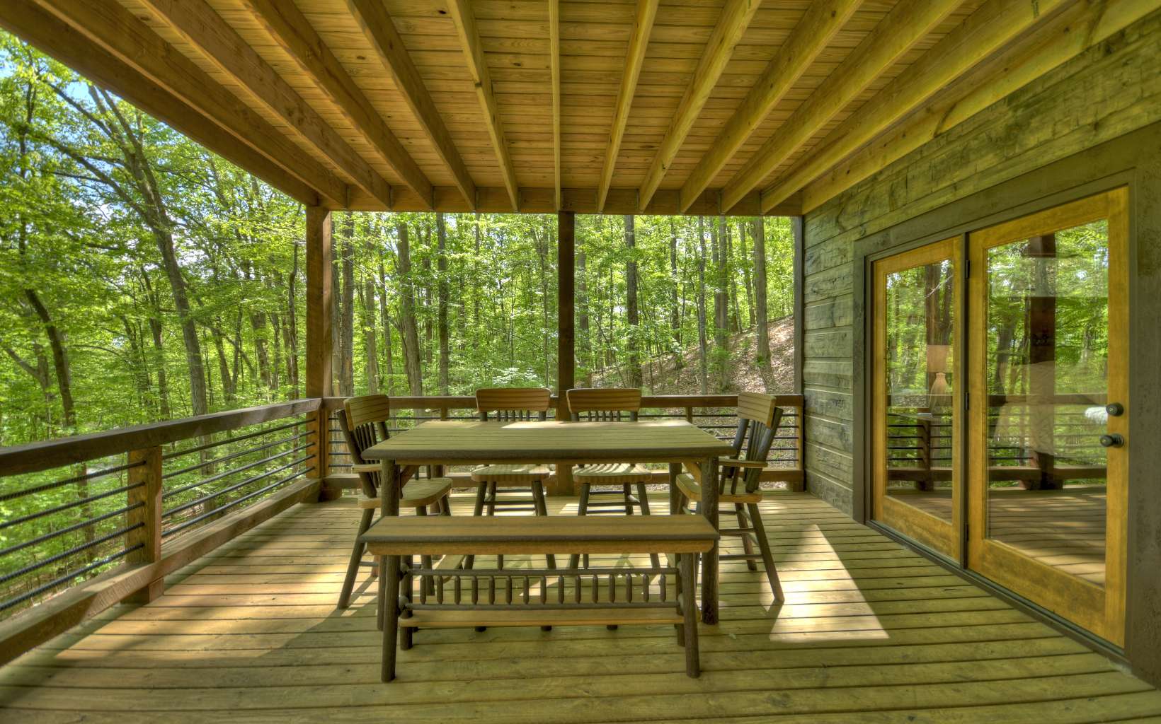 1641 Shady Falls Road Blue Ridge, GA 30513 - Photo 11 of 53 a view of a patio with a table chairs and wooden floor