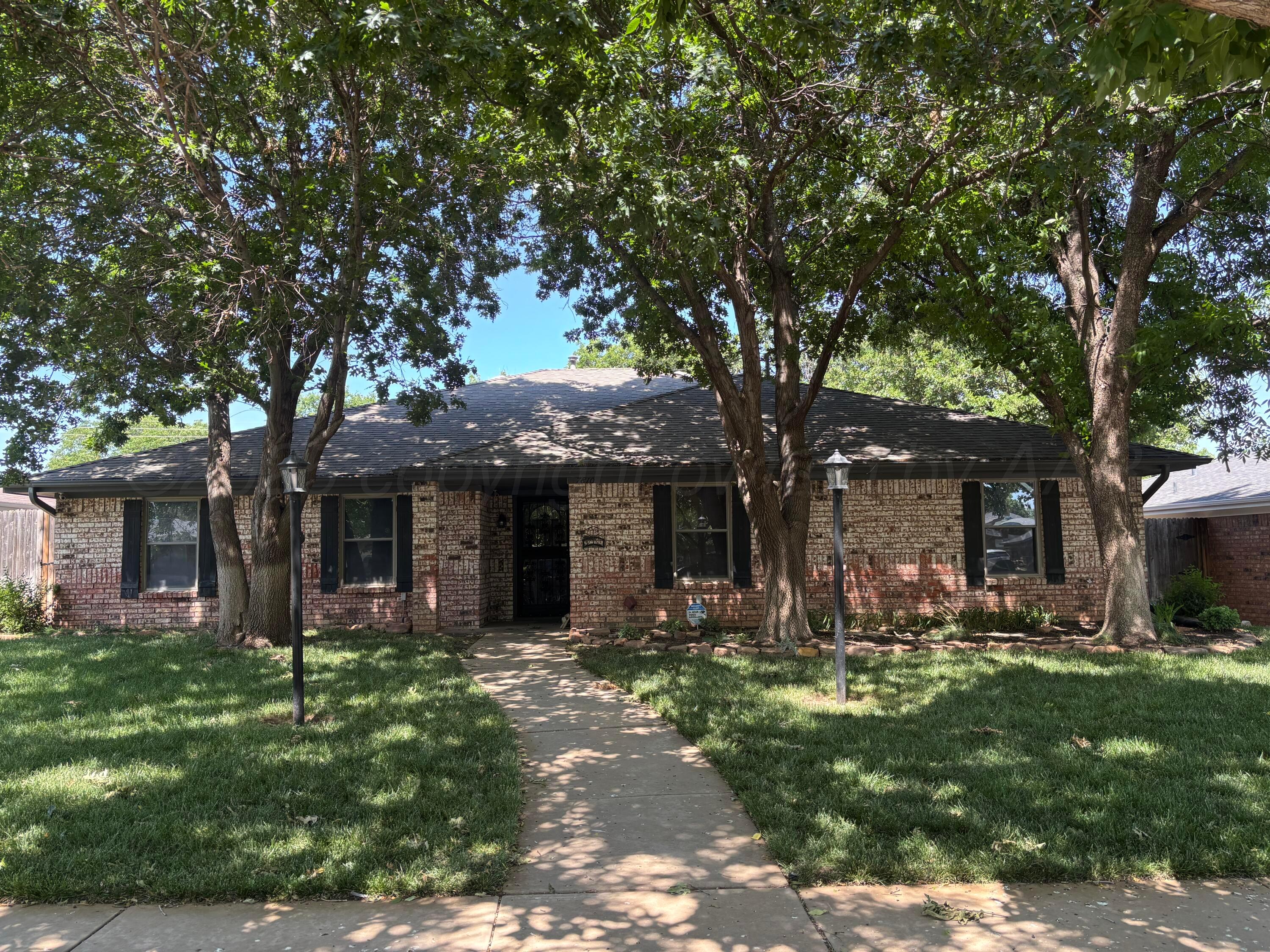7810 Farrell Drive Amarillo, TX 79121 - Photo 1 of 31 a front view of a house with a garden