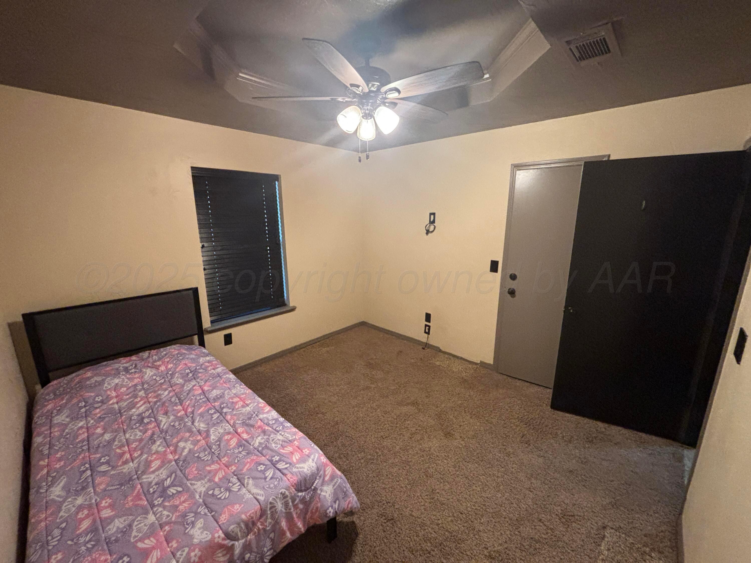 7810 Farrell Drive Amarillo, TX 79121 - Photo 11 of 31 a bedroom with a bed and a television