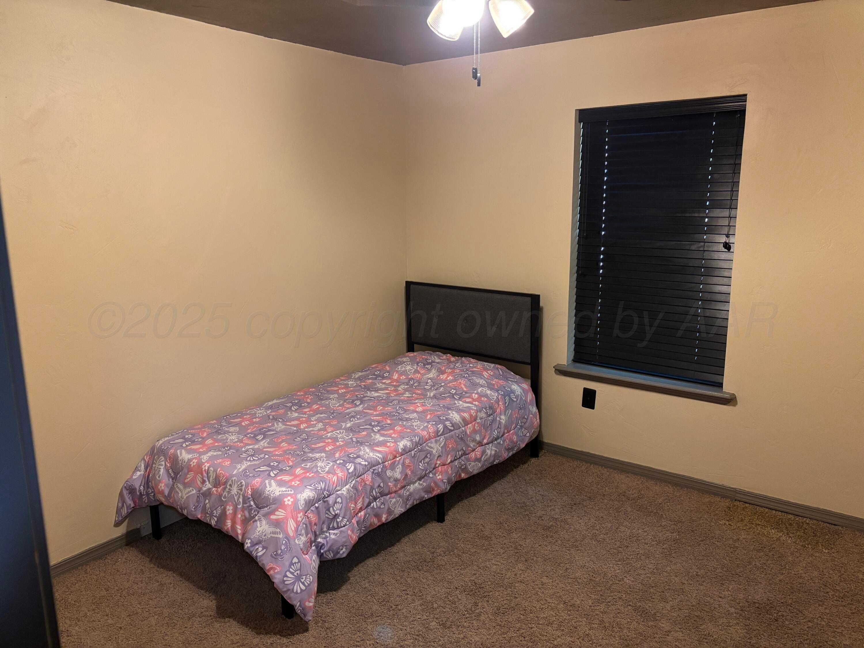 7810 Farrell Drive Amarillo, TX 79121 - Photo 13 of 31 a bedroom with a bed and a window