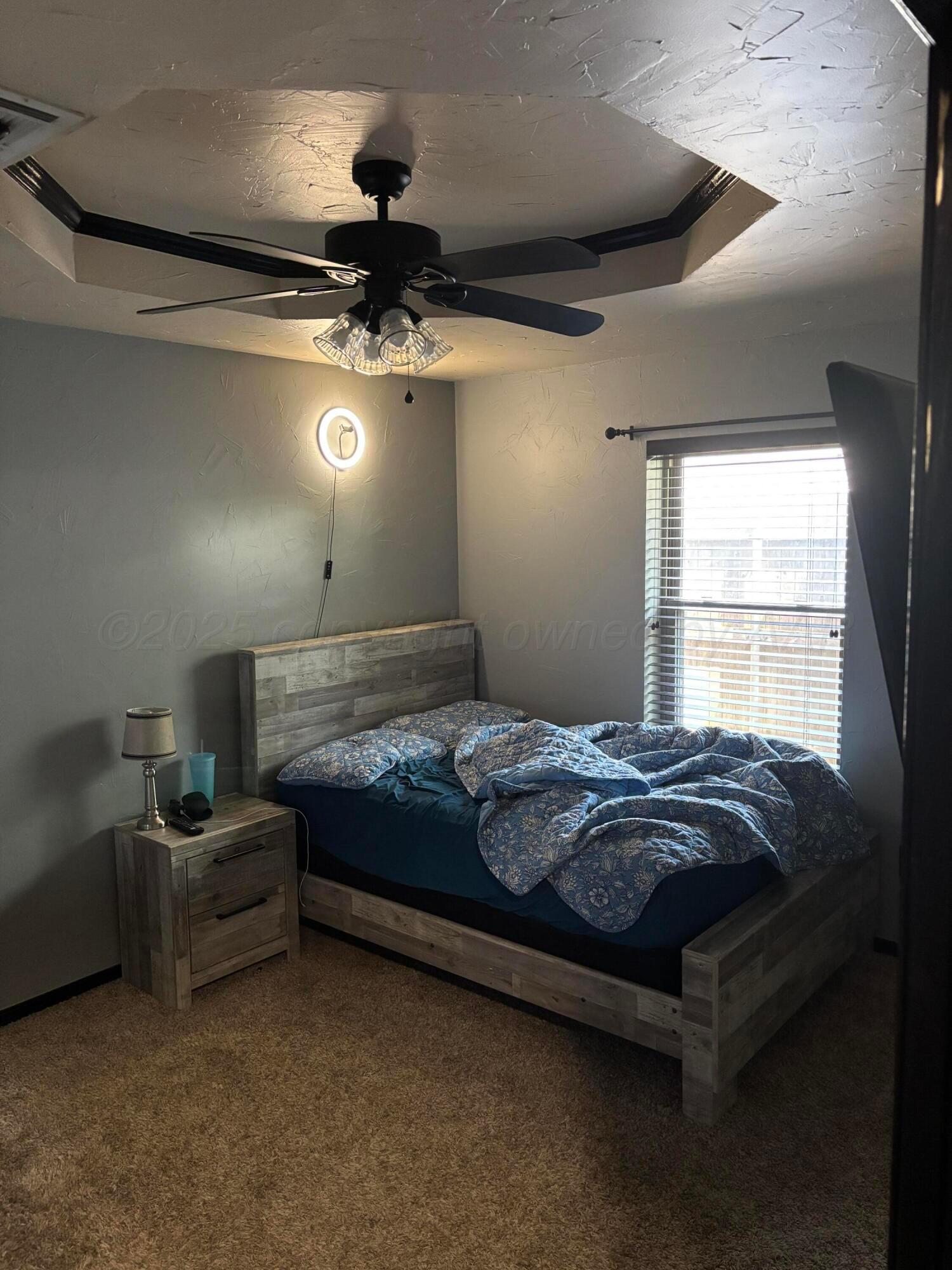 7810 Farrell Drive Amarillo, TX 79121 - Photo 16 of 31 a bed sitting in a room next to a window