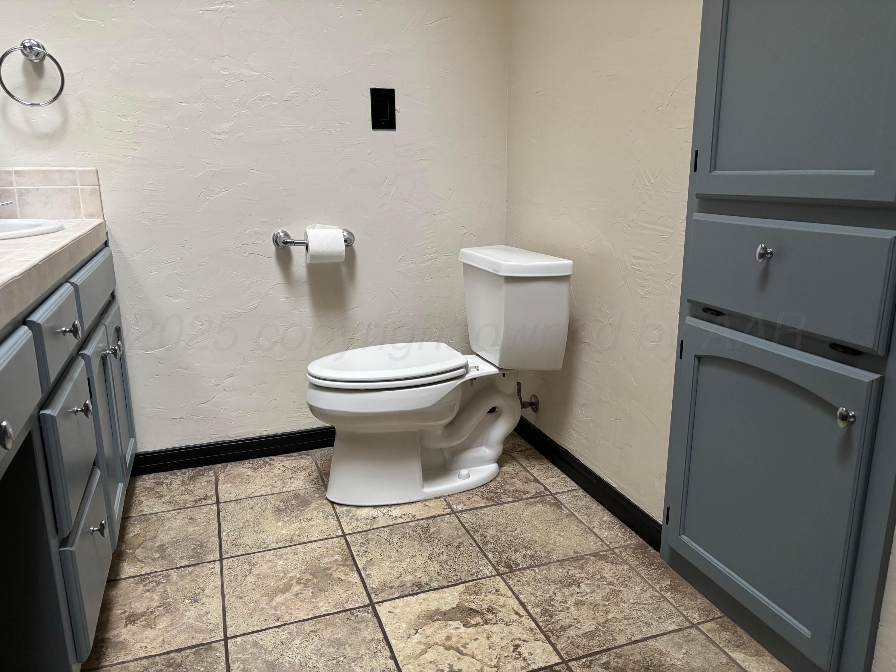 7810 Farrell Drive Amarillo, TX 79121 - Photo 24 of 31 a bathroom with a toilet and a sink