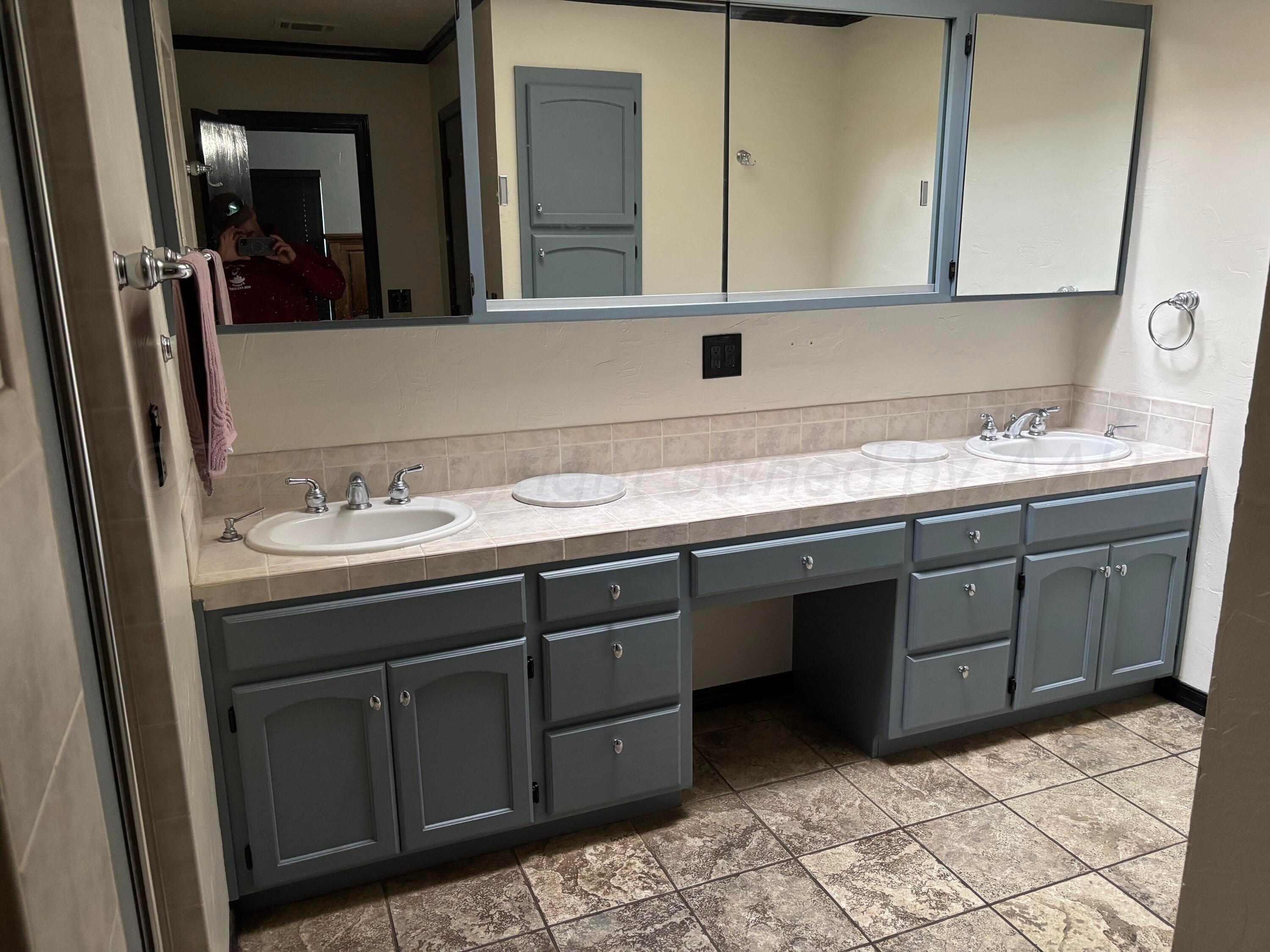 7810 Farrell Drive Amarillo, TX 79121 - Photo 25 of 31 a bathroom with a sink and a mirror
